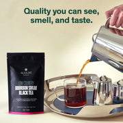 August tea package with a cup of tea being poured, on a beige background.