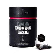 Black tea packaging with 'August' branding on a white background