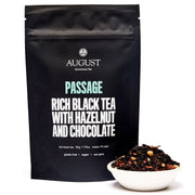 Black tea packaging with 'August' branding and a small bowl of tea leaves on a white background