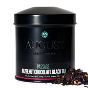 Black tea canister labeled 'August' with hazelnut chocolate black tea on a white background