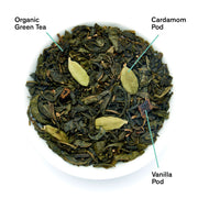 Organic green tea with cardamom and vanilla pods on a white background