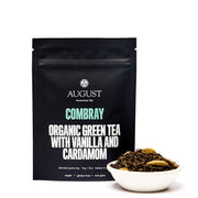 August Combray organic green tea with vanilla and cardamom packaging and tea leaves in a bowl on a white background