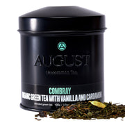 Black tea canister labeled 'August' with tea leaves on a white background