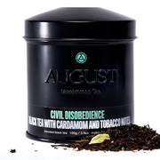Black tea canister labeled 'August' with tea leaves on a white background