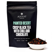 Black tea package labeled 'Painted Desert' with a bowl of tea leaves on a white background