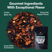 Tea blend with dried chili pepper pieces, cacao shell, and cinnamon on a green background with August Tea packaging.