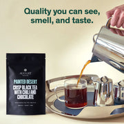 August Painted Desert Crisp Black Tea package with tea being poured into a cup on a tray.