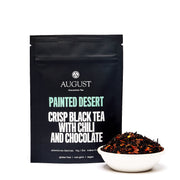 August Painted Desert Crisp Black Tea package with a bowl of tea leaves on a white background