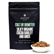 Black tea bag packaging with 'August Tea' branding and text about the tea's ingredients.