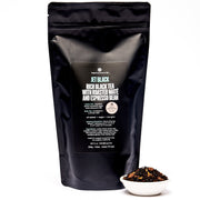 Black tea package with a small bowl of tea leaves on a white background