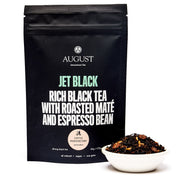 August Jet Black tea package with a bowl of tea leaves on a white background