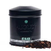 Black tea canister with 'August' branding and loose tea on a white background