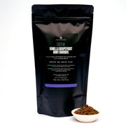 Black tea packaging with vanilla grapefruit mint rooibos flavor on a white background
