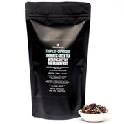 Black tea packaging with white text and a small bowl of tea leaves on a white background