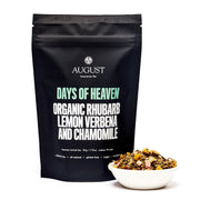 August tea package with 'Days of Heaven' tea and a bowl of tea leaves on a white background