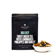 August tea package with a bowl of tea leaves on a white background