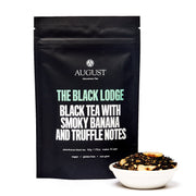 Black tea packaging with 'August' branding and tea description on a white background