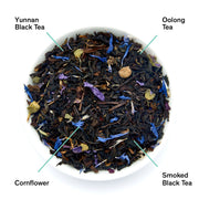 Tea leaves with labels for Yunnan Black Tea, Oolong Tea, Cornflower, and Smoked Black Tea.