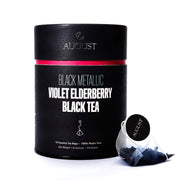 Black cylindrical tea packaging with 'August' branding and tea bags on a white background