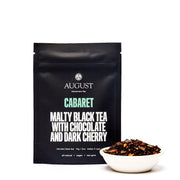 August Tea package for 'Cabaret' tea with a bowl of tea leaves on a white background
