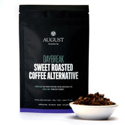 August Uncommon Tea Daybreak Sweet Roasted Coffee Alternative packaging with a bowl of product on a white background