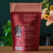 Red tea package with brewing directions on a wooden surface