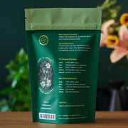 Green tea package with brewing instructions on a wooden surface