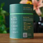 Tea packaging with brewing instructions and product details on a wooden surface.