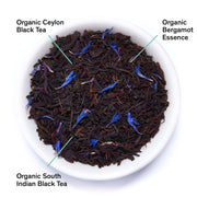 Tea leaves with labels for Organic Ceylon Black Tea, Organic Bergamot Essence, and Organic South Indian Black Tea.