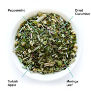  bowl of dried herbs with labels for peppermint, dried cucumber, Turkish apple, and moringa leaf