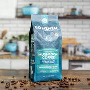 Go Mental Mushroom Coffee package on a wooden surface with coffee beans