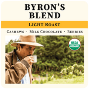 Byron's Blend coffee package with a man drinking coffee in a natural setting
