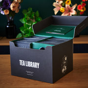 Tea Library packaging with tea bags on a wooden surface