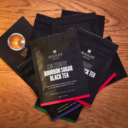 August tea packages on a wooden surface