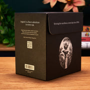 Black tea box with branding and text on a wooden surface