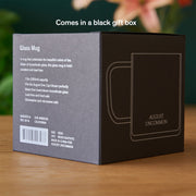 Black gift box with text and branding on a wooden surface