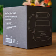 Box packaging for a Two Cup Glass Teapot with branding and product details.