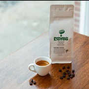 Daves Premium Coffee Roasters package with a cup of coffee and coffee beans on a wooden surface.
