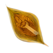 Powdered substance in a leaf-shaped container on a white background