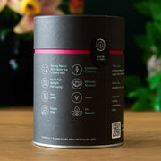 Tea packaging with certification icons on a wooden surface