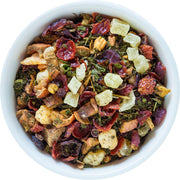 Assorted dried fruits and herbs in a white bowl