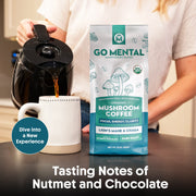Person pouring coffee from a black coffee maker into a white mug with a 'GO MENTAL' mushroom coffee package in the foreground.